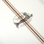 Close-up of a traditional surfboard featuring a logo with a fish and the words “Howler Brothers Custom Shapes Series,” plus two parallel wood inlays running diagonally across the white surface, reminiscent of classic noseriding boards.