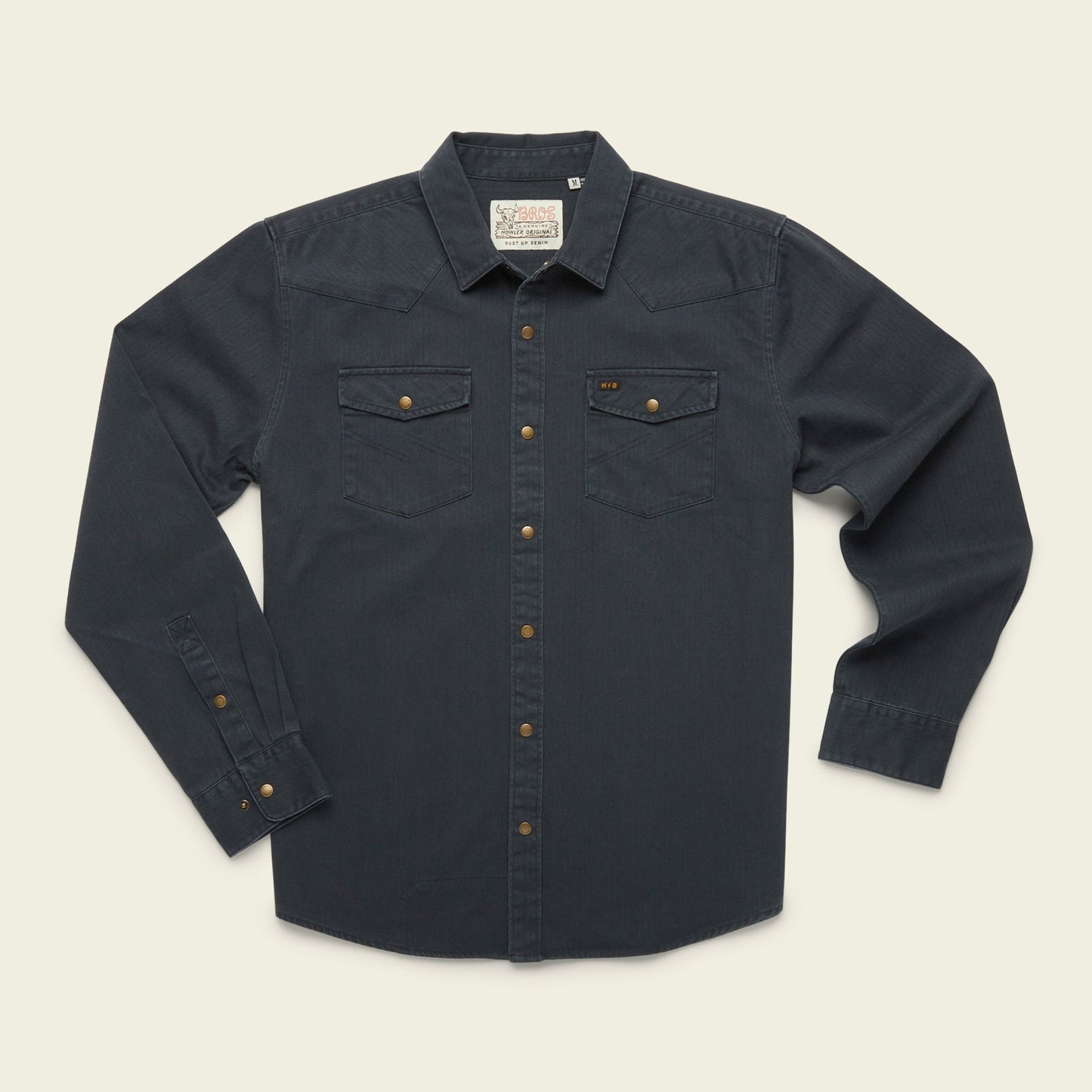 A rugged cotton Sawhorse Work Shirt in dark blue denim with long sleeves, front button closure, two flap chest pockets, and bronze-colored buttons, laid flat on a light background.