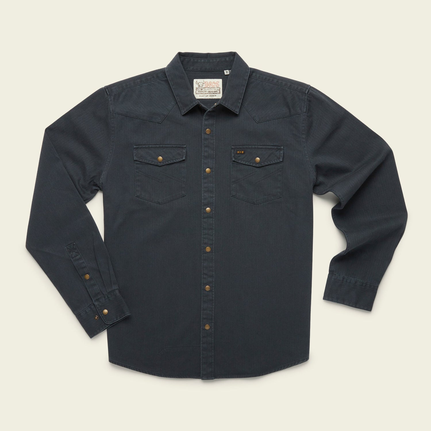 A rugged cotton Sawhorse Work Shirt in dark blue denim with long sleeves, front button closure, two flap chest pockets, and bronze-colored buttons, laid flat on a light background.