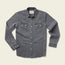 A long-sleeve, button-up gray Denim Snapshirt with two front chest pockets and white buttons, laid flat on a light beige background—perfect for those seeking versatile style.