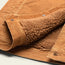 A close-up of the Fuzzy Depot Jacket, a tan corduroy jacket with soft, brown sherpa lining, featuring metal snap buttons and detailed stitching on the fabric.