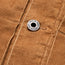 Close-up of a brown corduroy jacket from the Fuzzy Depot Jacket collection, featuring a metal button engraved with HOWLER BROS attached to a seam running vertically through the fabric.