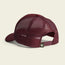 A maroon mesh trucker hat shown from the back, featuring an adjustable snapback closure and a small green tag with a cartoon monkey face logo near the strap—this vintage-inspired hat boasts classic retro style.