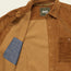 A brown wide wale corduroy travel shirt with the front open, revealing a blue inner pocket. The Iquitos Overshirt features a chest pocket and a Howler Bros label sewn inside the collar.
