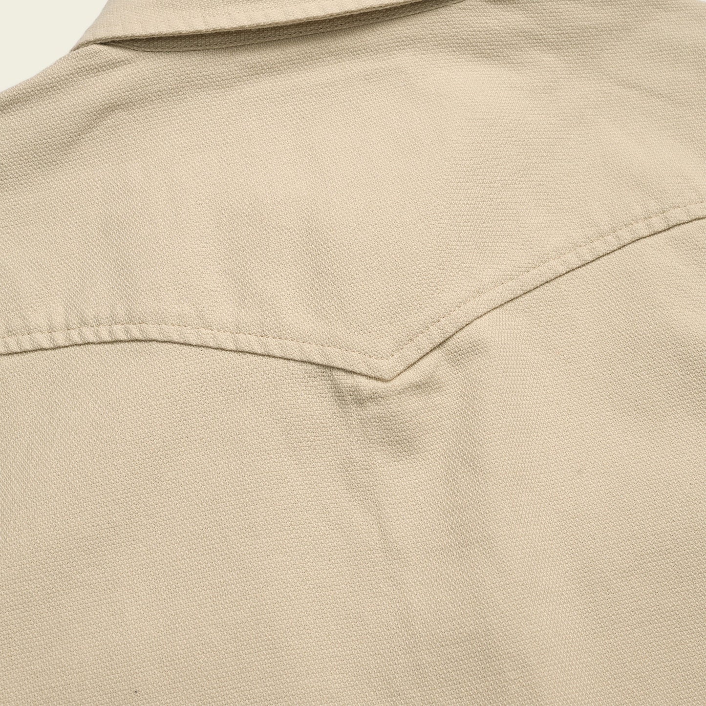 Close-up of the back yoke and collar of a beige Novato Shirt, showing textured canvas fabric and visible stitching details inspired by classic western shirt design.