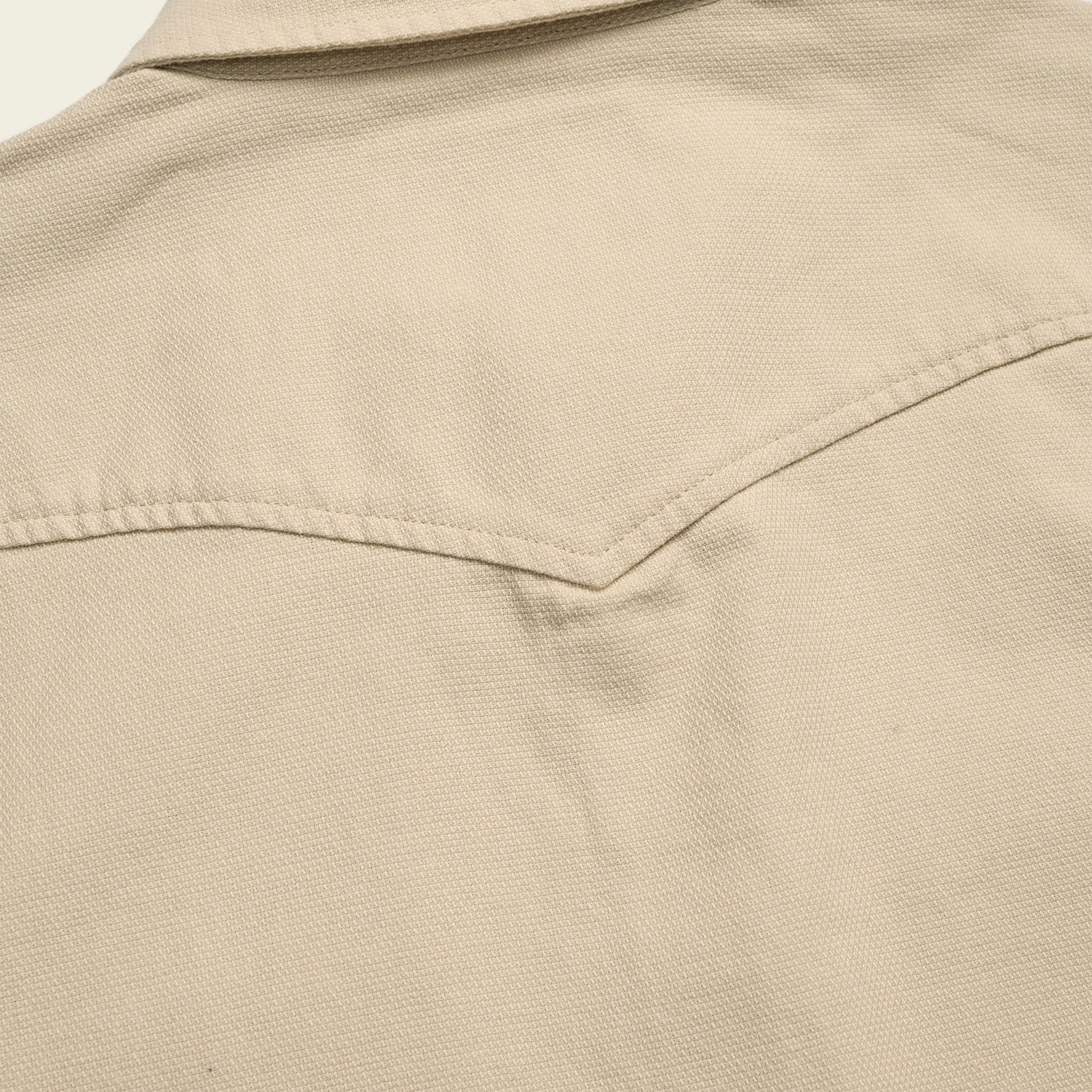 Close-up of the back yoke and collar of a beige Novato Shirt, showing textured canvas fabric and visible stitching details inspired by classic western shirt design.