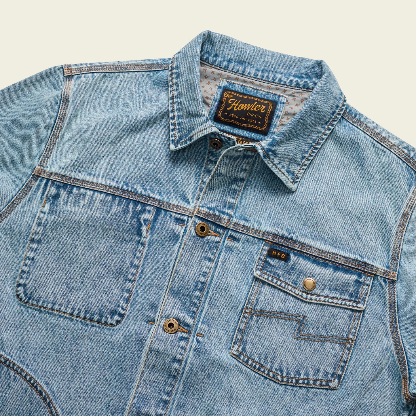 Light blue Depot Jacket denim jacket with large front pockets, button closures, and visible seams. The collar is folded, and a label on the inside reads Homler in yellow text with additional details.