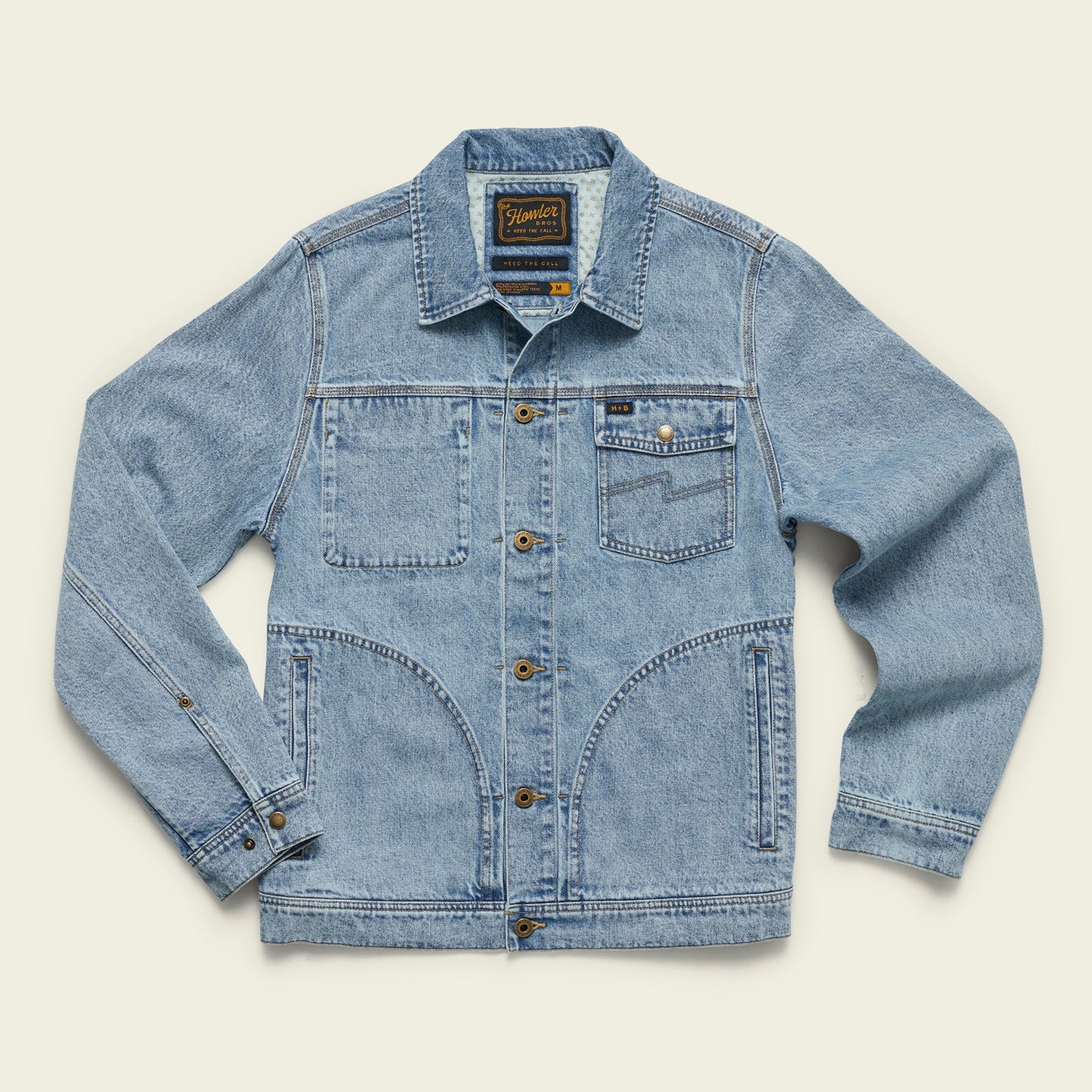 Light blue Depot Jacket denim jacket featuring brown buttons, visible lightning bolt stitch, two chest pockets (one with a button), and two large lower front pockets, laid flat on a light background.