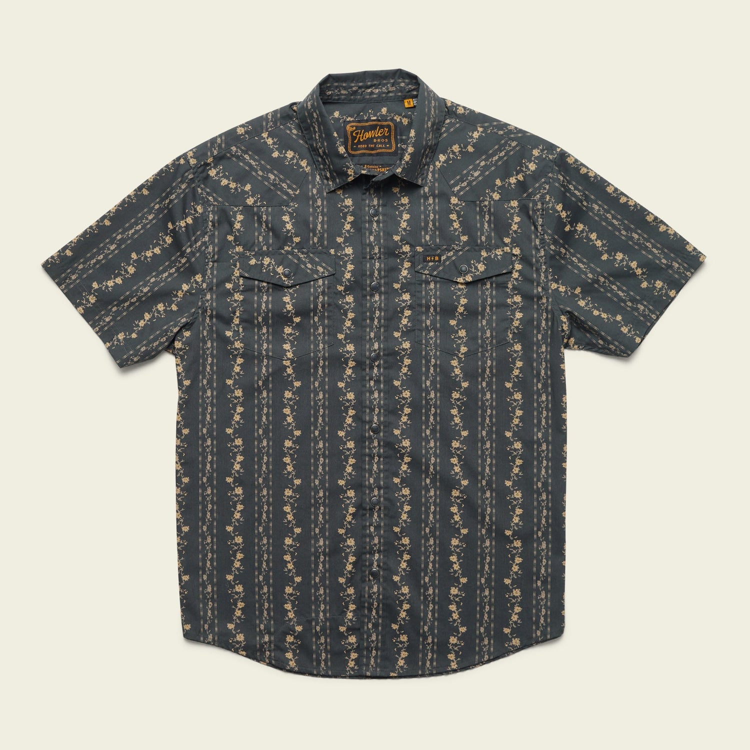 Short-sleeve button-up western shirt with a dark background and vertical floral stripe pattern, featuring two front chest pockets with button flaps and classic pearl snaps.