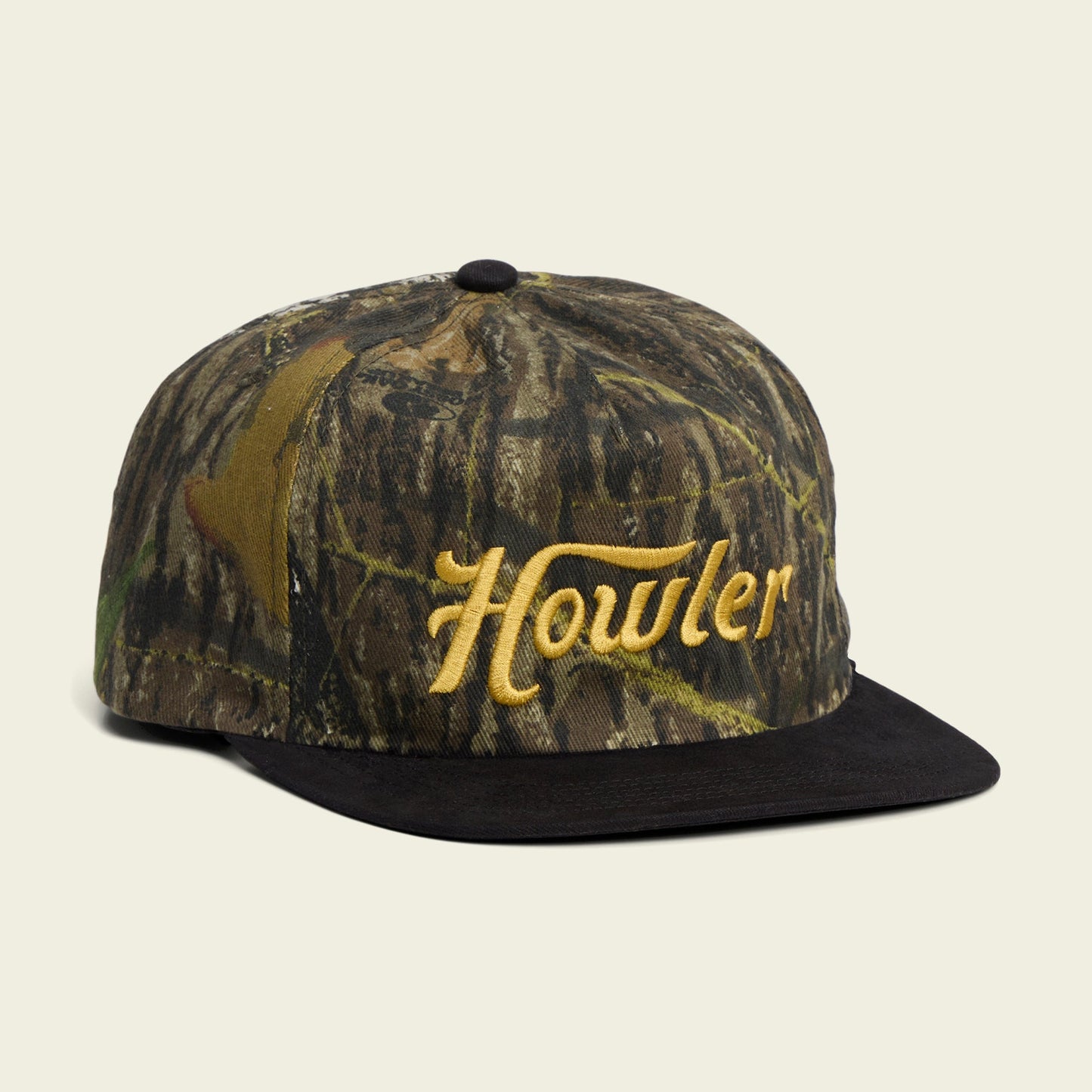 A camouflage-patterned baseball cap with a black brim and the word Howler embroidered in yellow on the front, featuring an adjustable snapback closure and a soft crown for all-day comfort.