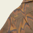 A close-up of a brown and tan patterned buttery soft flannel fabric with the word Howler embroidered in yellow on the shoulder area of a garment, possibly a jacket or shirt.