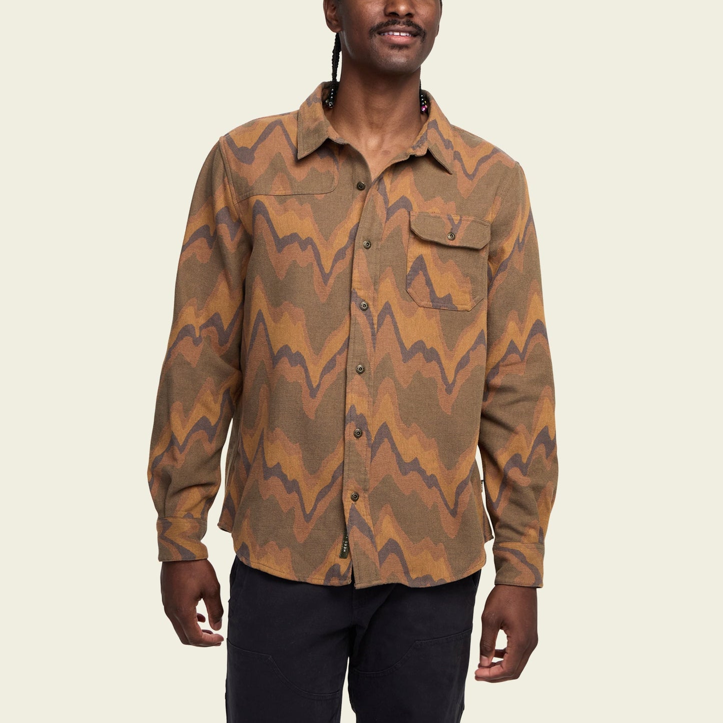 A person wearing a buttery soft Harkers Flannel zigzag patterned button-up shirt with a chest pocket, standing against a plain light background.