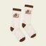 A pair of white crew socks with brown toes, heels, and cuffs, featuring embroidered retro-style flowers from the Flower Power Collection and the word Howler on the sides.