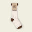 A pair of white socks with brown toes, heels, and cuffs. Part of the Flower Power Collection, the socks feature Howler and a floral design on a cardboard label at the top.