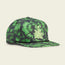 A green and black tie-dye baseball cap inspired by Austin FC, featuring an embroidered plant design and the letters F C on the front. This stylish Howler Brothers snapback has a flat brim and a decorative black rope across the crown’s base.