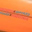 Close-up of orange surface featuring HOWLER BROS x SUPER73 repeated in pink and blue text, separated by a black line—highlighting the vibe of a Lightning Powered Surf Machine.