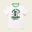 White t-shirt with green accents from the Verde Collection, featuring a cartoon monkey in a green hat holding a soccer ball. Text above reads SOMOS VERDES AUS TEX and below Howler BROTHERS—a nod to Austin FC vintage t-shirts.