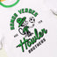 White t-shirt with green trim featuring a cartoon monkey in a green outfit juggling a soccer ball. Part of the Verde Collection, this piece nods to Austin FC with bold SOMOS VERDES AUS TEX Howler BROTHERS lettering in green and black.