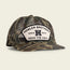 A camouflage-patterned mesh baseball cap with a white patch on the front. Features an adjustable snapback closure and reads HOWLER BROTHERS AUSTIN TEXAS HEED THE CALL in black letters with a bold H in the center.