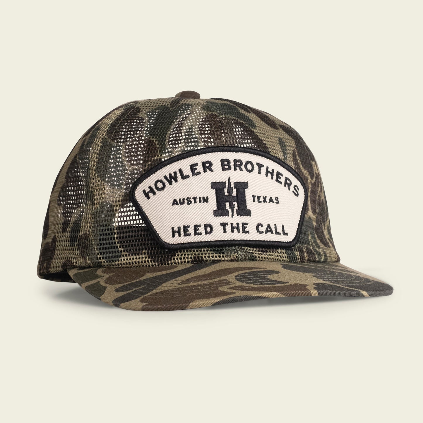 A camouflage-patterned mesh baseball cap with a white patch on the front. Features an adjustable snapback closure and reads HOWLER BROTHERS AUSTIN TEXAS HEED THE CALL in black letters with a bold H in the center.