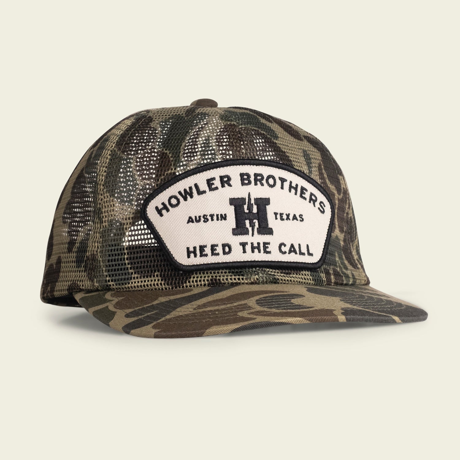 A camouflage-patterned mesh baseball cap with a white patch on the front. Features an adjustable snapback closure and reads HOWLER BROTHERS AUSTIN TEXAS HEED THE CALL in black letters with a bold H in the center.