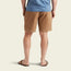 A person wearing a blue shirt, brown flip-flops, and Pressure Drop Cord Shorts made from stretch cotton corduroy for all day comfort is shown from the back, standing against a plain light background.