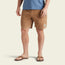 A person wearing a blue t-shirt, Pressure Drop Cord Shorts made from stretch cotton corduroy for all day comfort, brown sandals, and a ring, standing against a plain light background.