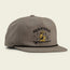 A gray Unstructured Snapbacks hat features an embroidered yellow dog in a cowboy hat sitting on a log with stars, a crescent moon, and “HERMANOS” above. The soft crown and adjustable snapback closure ensure a comfortable fit.