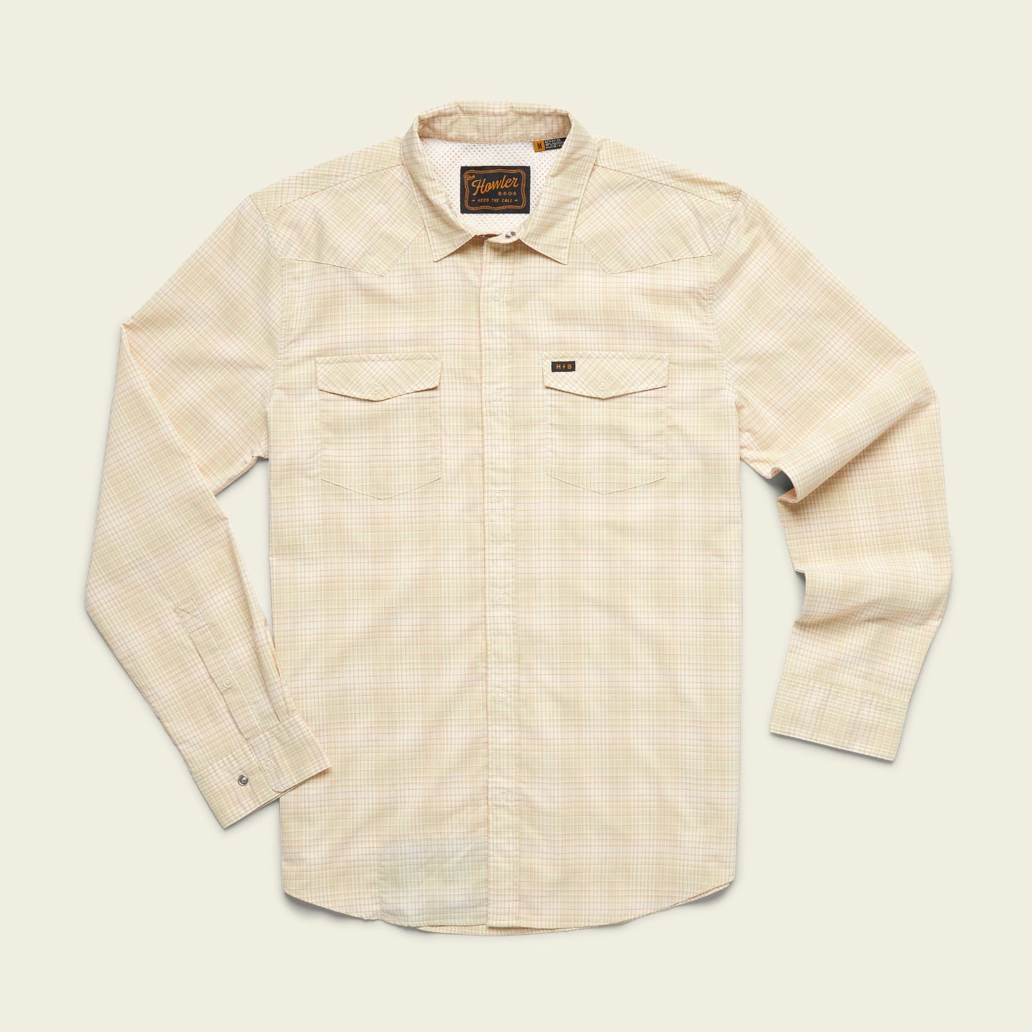 A long-sleeve, light beige plaid lightweight stretch shirt with two chest pockets, a collar, and vented yoke detail, laid flat on a plain off-white background.