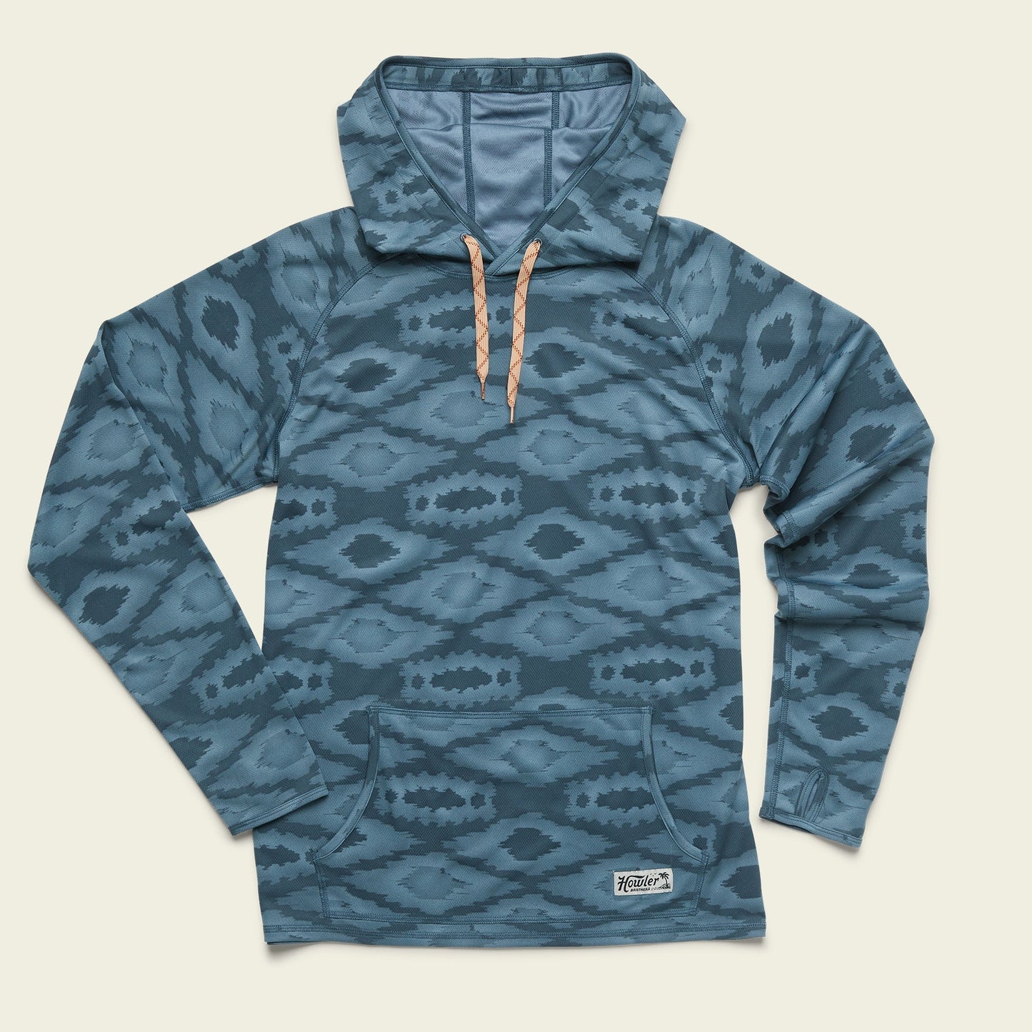 Blue patterned pullover hoodie with a high collar, light brown drawstrings, long sleeves, and a front kangaroo pocket. Made from recycled polyester, this UPF 35+ hoodie offers added sun protection and features a small white logo patch near the hem.