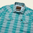 A turquoise and white plaid lightweight stretch shirt with two chest pockets, a Howler Bros label above the left pocket, and a vented yoke. The shirt is neatly laid flat on a light background.