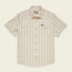 A vintage inspired shirt, this short-sleeve, button-up Howler Brothers features light beige and tan vertical stripes, chest pockets with flaps, pearl snaps, and a pointed collar, laid flat on a neutral background.