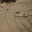 Close-up of a khaki textured shirt crafted from recycled polyester, featuring snap buttons, a flap chest pocket with a snap closure, and a small black Howler brand tag above the pocket.