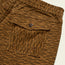 Close-up of Pressure Drop Cord Shorts in stretch cotton corduroy, featuring a flap pocket with a black button and two metal eyelets, showcasing a textured, striped pattern and an elastic waistband for ultimate comfort.