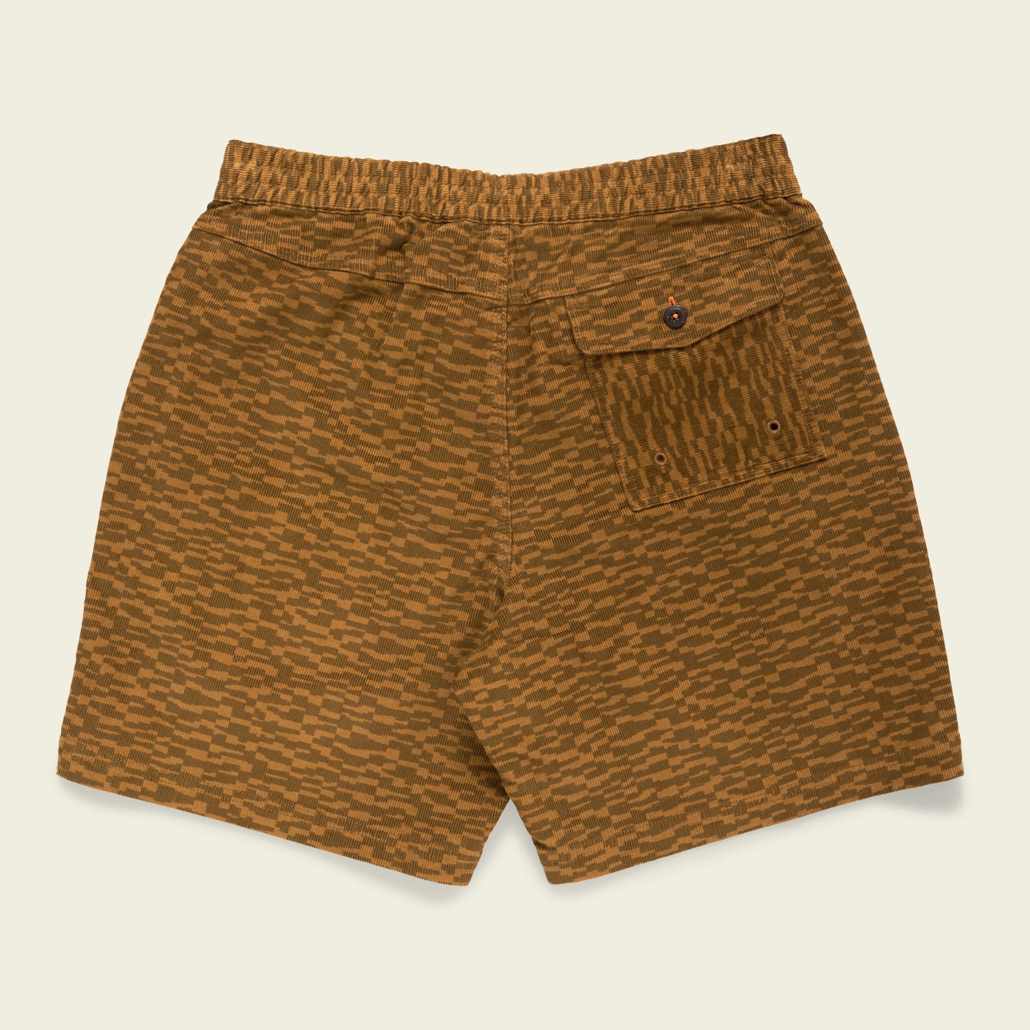 Brown patterned Pressure Drop Cord Shorts with an elastic waistband, single back pocket with a button flap, and overall textured design in stretch cotton corduroy, displayed against a light background.