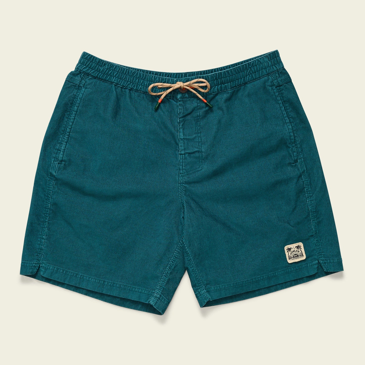 Teal Pressure Drop Cord Shorts with an elastic waistband, beige drawstring, side pockets, and a small stitched palm tree patch on the lower left leg. These comfortable shorts are displayed flat on a neutral background.