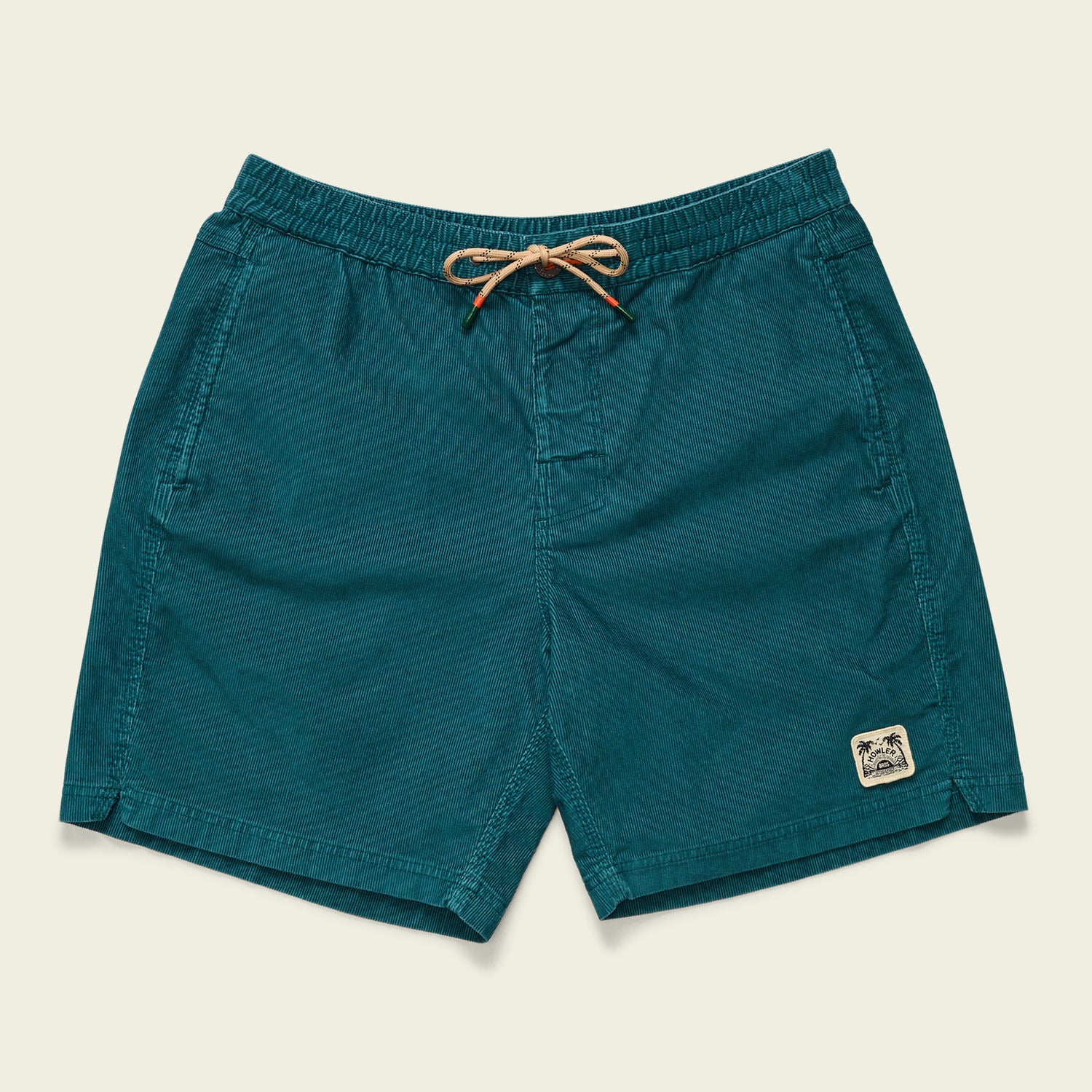 Teal Pressure Drop Cord Shorts with an elastic waistband, beige drawstring, side pockets, and a small stitched palm tree patch on the lower left leg. These comfortable shorts are displayed flat on a neutral background.