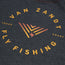 Dark gray shirt from the JT Van Zandt Collection featuring a circular logo that reads VAN ZANDT FLY FISHING in yellow-orange text, with TEXAS and COAST on either side—a tribute to the Texas coast. Part of the Howler Select T-Shirts series.