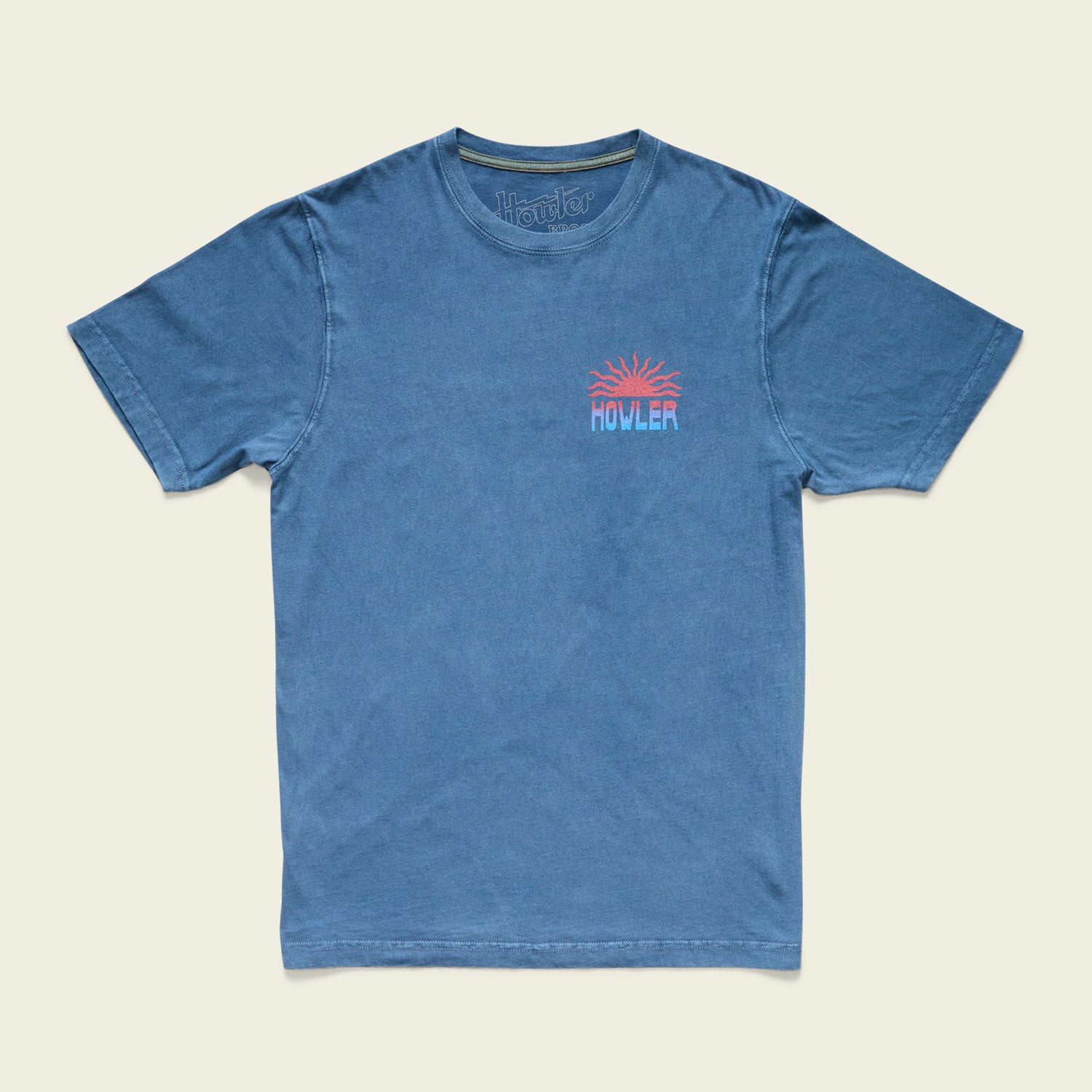 Blue short-sleeve t-shirt with a small, colorful graphic of an orange sun above the word HOWLER on the left chest. Made from resin-washed cotton for a soft, vintage look, it features a relaxed fit and crew neckline.