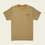 A beige lightweight UPF shirt with short sleeves, a small Howler Brothers logo graphic on the left chest, and an orange accent inside the collar. Made from a polyester spandex blend, the shirt is laid flat on a light background.