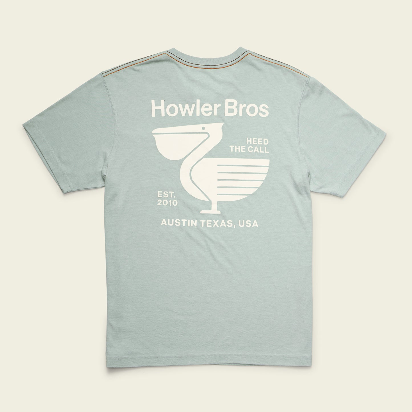 A light blue Howler blended t-shirt crafted from a soft cotton-poly blend, featuring a white graphic on the back of a stylized bird, Howler Bros, Heed The Call, Est. 2010, and Austin Texas, USA in bold text for maximum comfort and style.