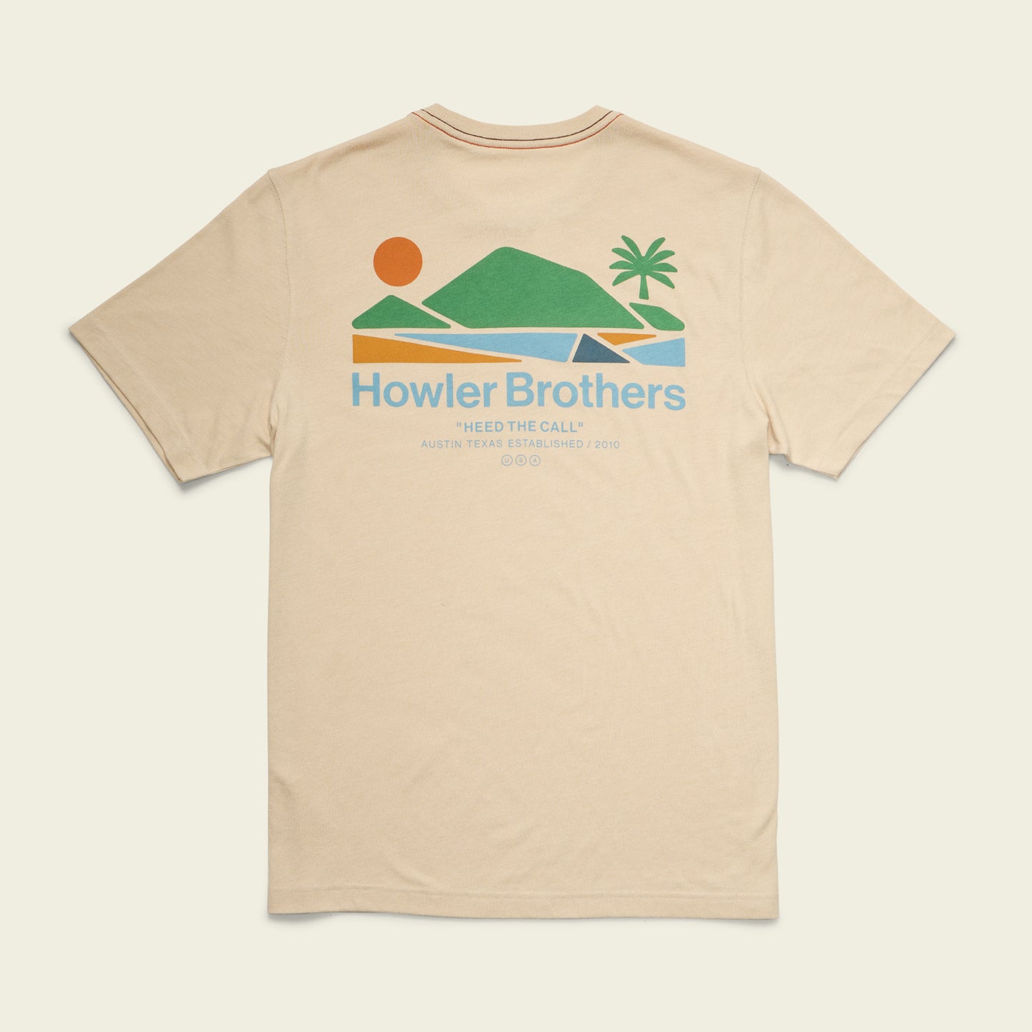 Beige t-shirt with a colorful graphic of a sun, mountains, water, and a palm tree on the back. Text reads Howler Brothers and Heed the Call, Austin Texas Established 2010 in blue and orange.