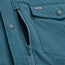 Close-up of a lightweight teal jacket showing a zippered pocket with mesh lining and a buttoned flap pocket. A small stitched tag above the pocket displays the initials H B with a lightning bolt between the letters.