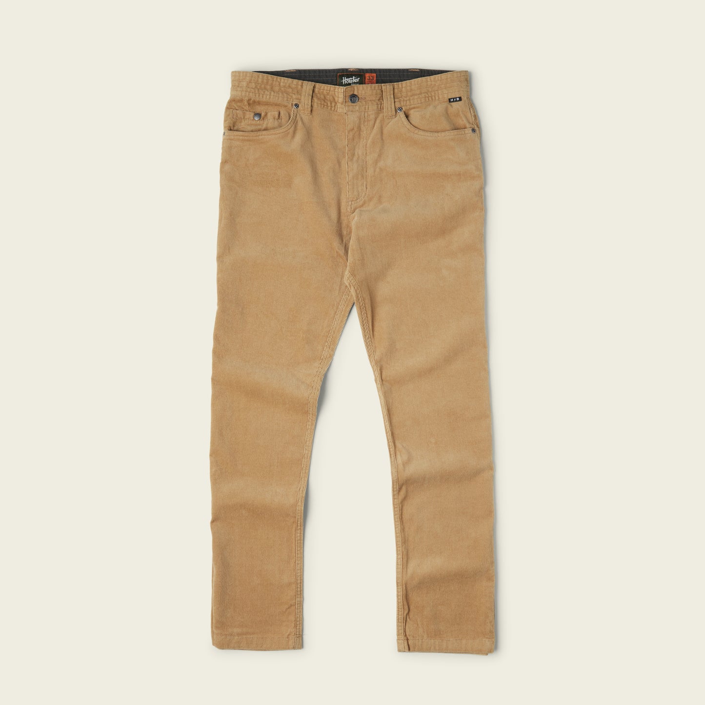 A pair of tan corduroy pants with front and back pockets, belt loops, and a button closure, laid flat on a light background.