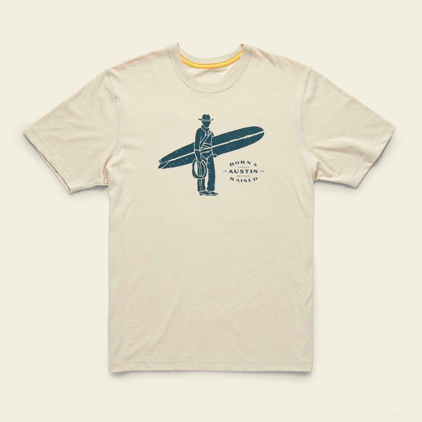 A beige T-shirt from the Howler Select T-Shirts collection featuring classic Howler designs: a person in a suit and hat holding a surfboard, with Born & Austin Raised beside the figure, crafted from a soft cotton-poly blend.
