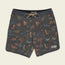 Patterned Bruja Boardshorts with a drawstring waist, featuring colorful dinosaurs and plants on a dark background with scattered dots. Stretchy fabric and draining front pockets add comfort and function. A Howler Bros patch is sewn near the bottom hem.