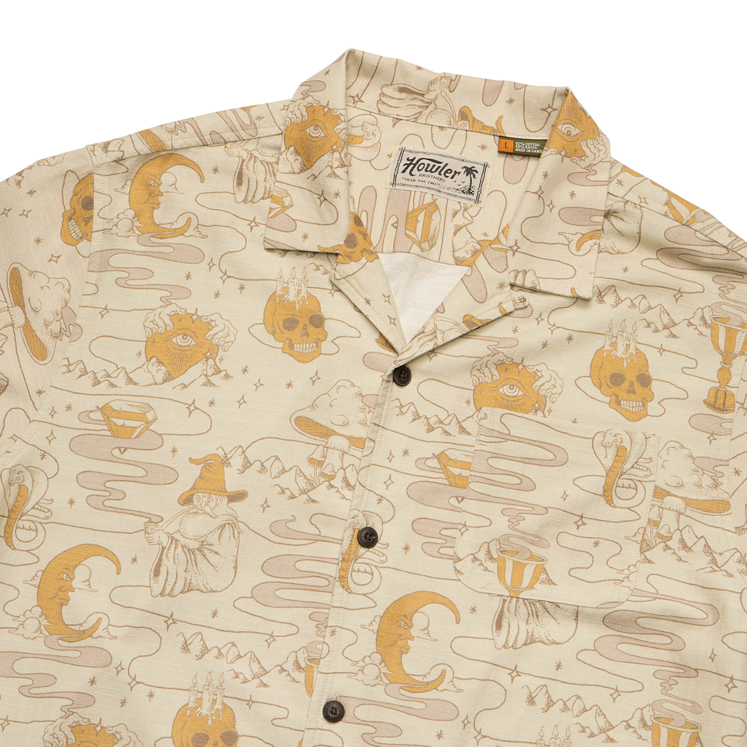 Beige button-up shirt in soft slub fabric with a mystical-themed print inspired by vintage Hawaiian shirts—skulls, crescent moons, snakes, and more in light brown and gold. Features a camp collar and visible Howler brand label inside the collar.