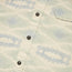 Close-up of a lightweight cotton shirt with a subtle abstract blue pattern, black buttons, and a single pocket on the right side—ideal for pairing with your favorite sunglass cleaning microfiber.